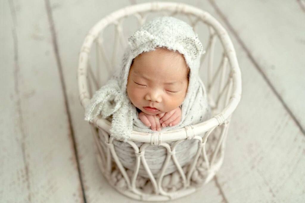 Baby sleeping in basket in her Olney, MD In-Home Newborn Photography Session