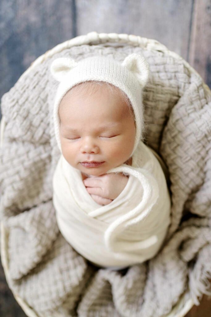 Newborn wrapped with bear hat during Ellicott City Photography Session