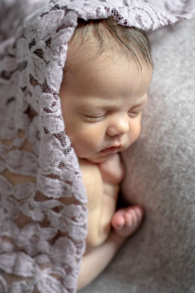 Woodbine Newborn Photography Session featuring baby sleeping with purple lace layer