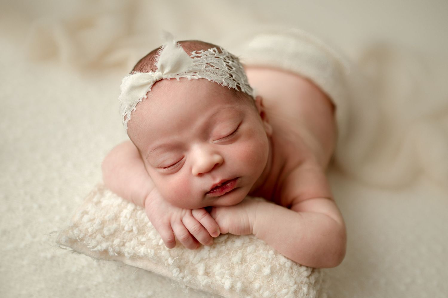Newborn posed on creamy neutral setup during her Newborn Photography Session in Howard County
