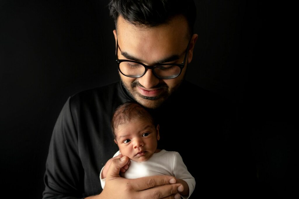 Dad admiring baby during their Family Photography Session in their Reisterstown, MD home