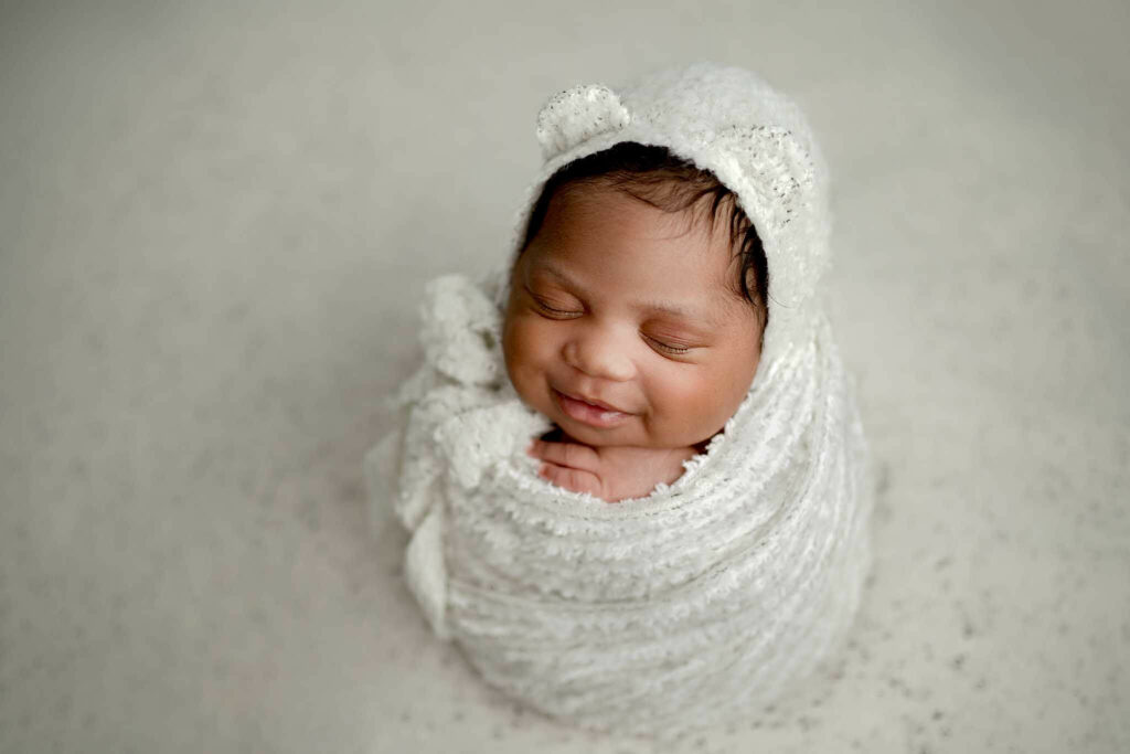 Newborn wrapped with a bear bonnet during Baltimore Maryland Photo Session