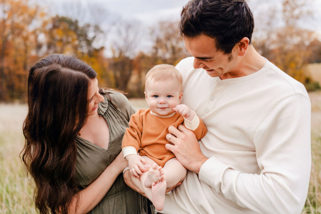 Howard County Family admires their adorable baby during their fall photo session