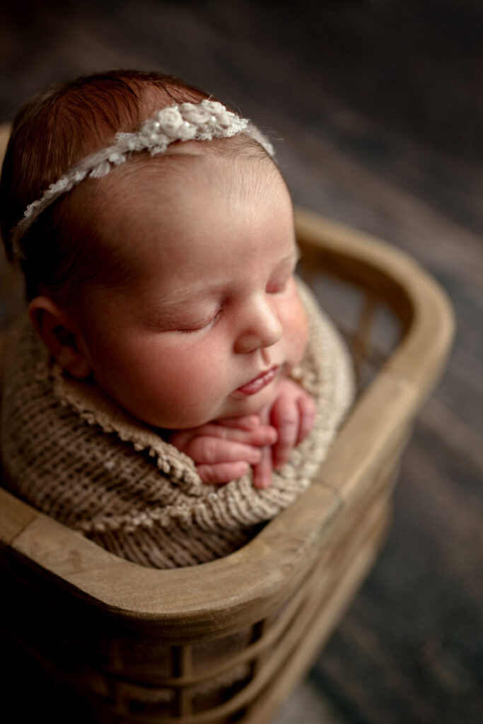 baby girl posed in browns during her newborn photo session in Ellicott City, MD