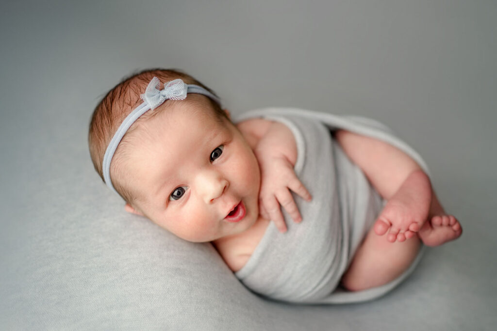 Ellicott City baby girl in blues awake during her newborn photo session