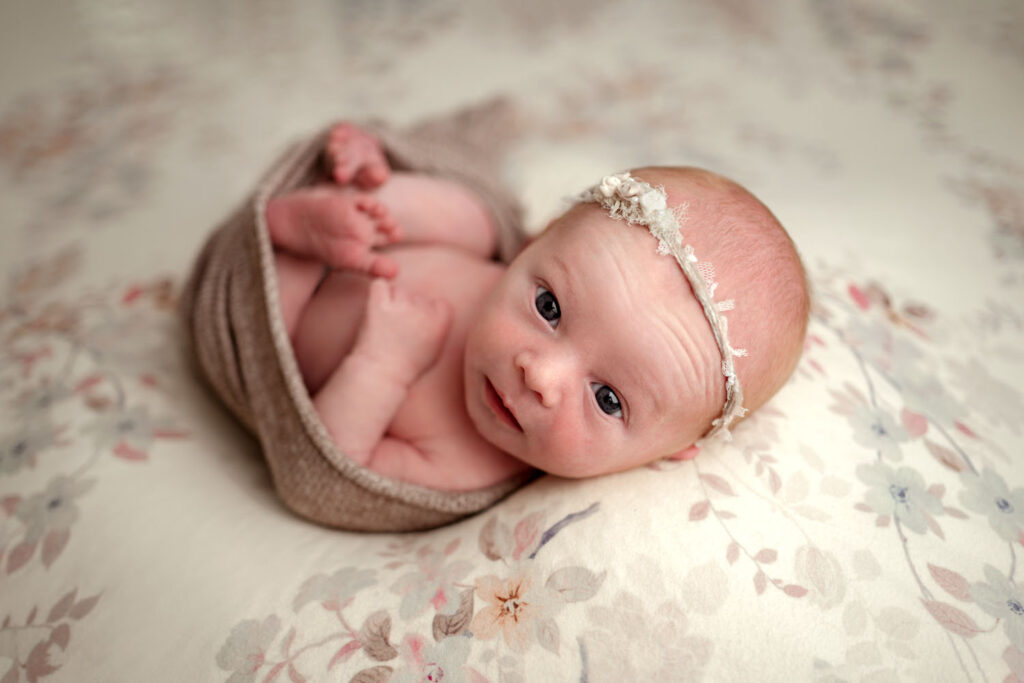 Awake baby looks at the camera during her photo session in Sykesville, MD