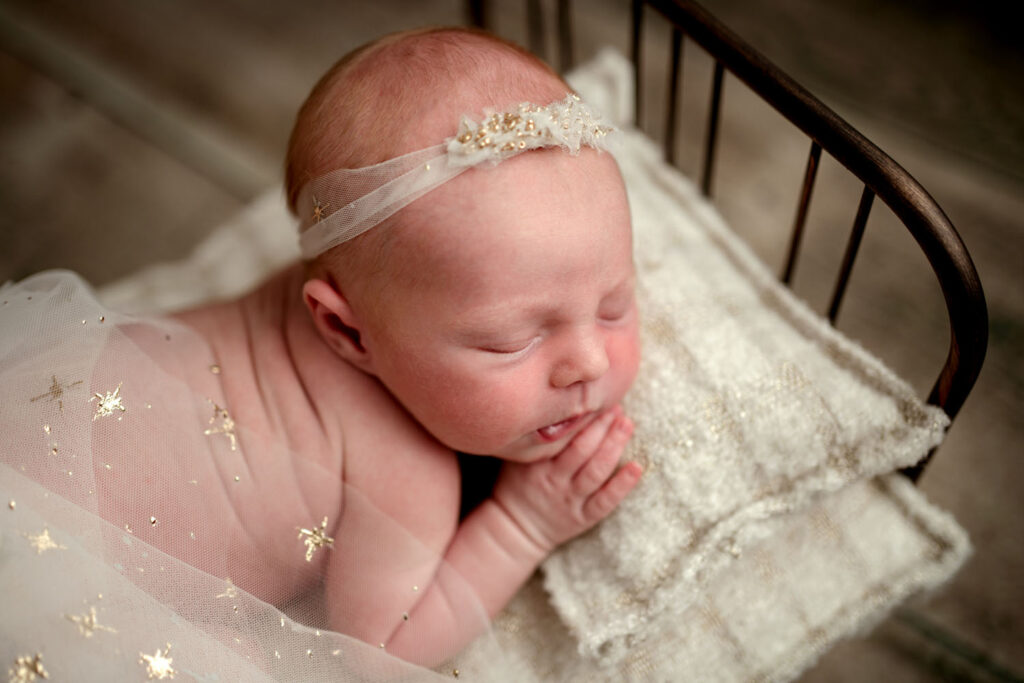 baby girl in a bed prop with white and gold theme in Sykesville, MD
